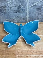 Top view of blue butterfly-shaped dish