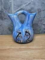 Front view showing Kokopelli figures and marbled glazing