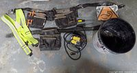 Overall view of tool belt, suspenders, outlet box, bucket and tools
