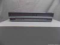 Front view showing DVD tray, VHS slot and control panel