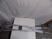 Full view of both crutches laid parallel on table