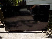 TV powered on showing settings menu outdoors