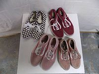 All four pairs of Vans sneakers top view on white table