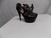 front and side view of both shoes showing platform and straps