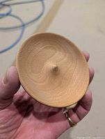Top view showing shallow dish, central peak, beechwood grain