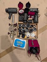 Overview of entire lot showing lenses, focusing rail, grip, cases and accessories