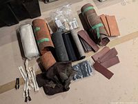 Array of leather rolls, blanks, dye bottles and fabric