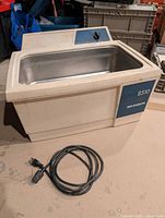 Full view of Branson 8510 ultrasonic cleaner with power cord coiled in front