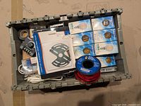 Grey tote with LED bulbs, wire spool and assorted components
