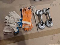All items laid out: cotton gloves, orange gloves, mixing paddle, two suction lifters