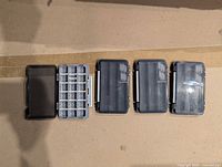 Four organizer cases closed on surface