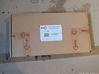 Closed carton with Noico label and tape