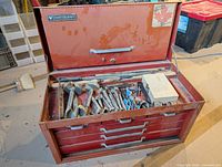 Chest open showing tools in top compartment