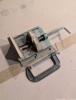 Top view of drill press vise showing wood jaw inserts and Mastercraft C-clamp