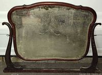 Front view of dresser mirror showing wood frame and tarnished glass