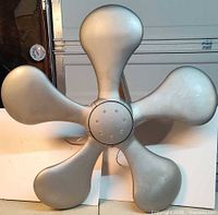 Front view showing five rounded gray blades and hub