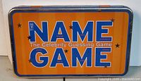 Front view of The Name Game tin