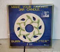 Front view of sealed Candle Capper showing venting plate design and packaging text