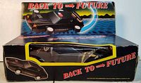 Front view of toy in box showing Back To Future branding and car design