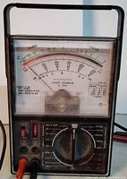 Front view of Micronta multimeter showing scale, selector dial and probes