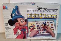 Front of boxed Milton Bradley Disney Light & Learn game showing artwork and title