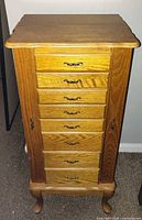 Front view showing seven drawers and cabriole legs