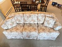 Top view of sofa showing floral upholstery, cushions, pillows