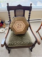 Full front view of chair with cushion showing frame, upholstery, legs