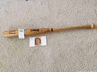 Full view of Cooper Pro League 78 bat with card beside for scale