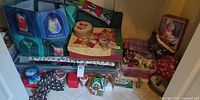Wide shot of entire lot in closet showing ornaments, boxes, tins, gift wrap and figurines
