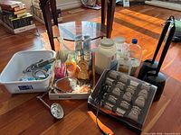 Overall lot showing hot rollers, toilet brush, Epsom salts jug, Febreze, dishpan, mirrors, misc items