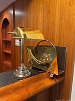 Desk lamp and magazine rack side by side on countertop