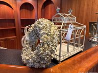 Birdcage and wreath together on countertop