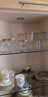 Glass stemware on upper shelf: Tiffin coupes, Lenox wine glasses, Lenox tumblers