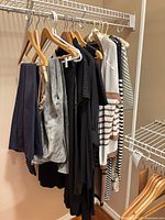 Rack with multiple dresses, tops and pants