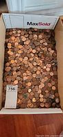 Full view of box filled with loose pennies
