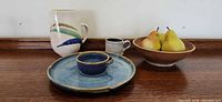 Group view of pitcher, mug, chip platter with dip bowl, fruit bowl with pears
