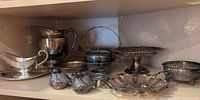 Group shot of all silver plate pieces on shelf