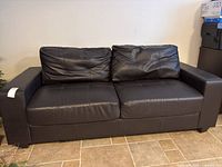 Front view of espresso two-seat faux leather sofa