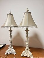Full view of both ivory lamps on table