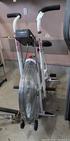 Full view of Schwinn AirDyne stationary bike showing fan wheel, frame, seat, and pedals