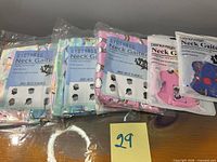Five sealed neck gaiter packs with lot sticker