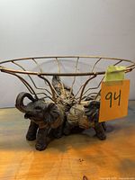 Full view of wire bowl on elephant base