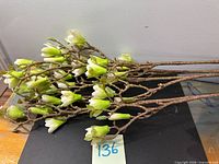 Four artificial flower stems laid flat showing length and quantity