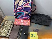 Overview of travel bag, five wallets, black toiletry bag