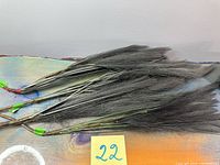 Full bundle of charcoal/black faux dried grass sprays on tabletop