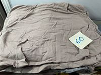 Folded beige embroidered duvet cover showing fabric and embroidery