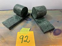 Both green marble bookends on table, front view