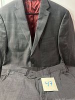 Jacket and pants laid out showing overall condition and color