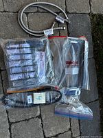 All four items grouped: hoses, rack kit, grill plate, hardware